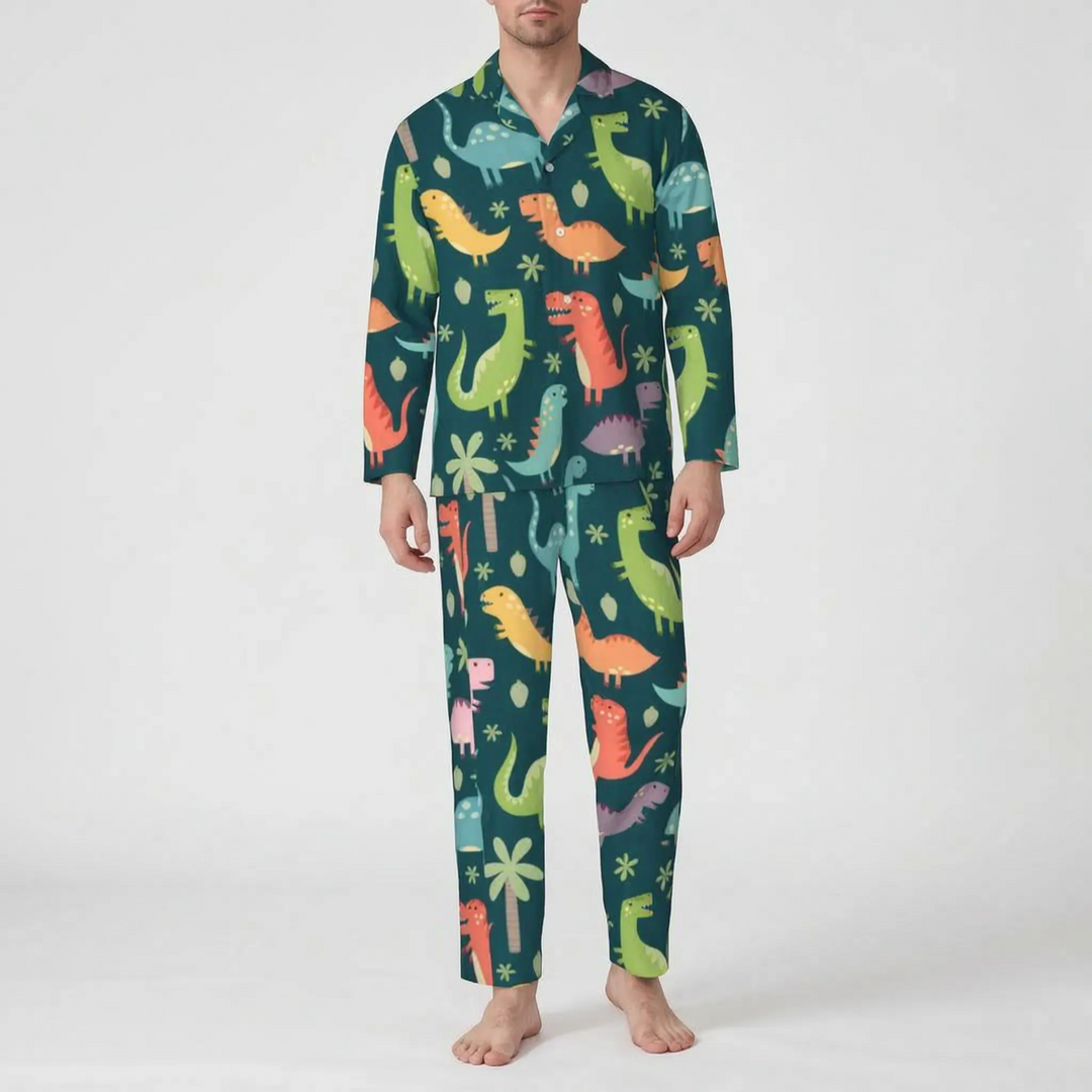 Front view of a model wearing the dark teal pajama set printed with orange, green and blue cartoon dinosaurs and palm trees. 9