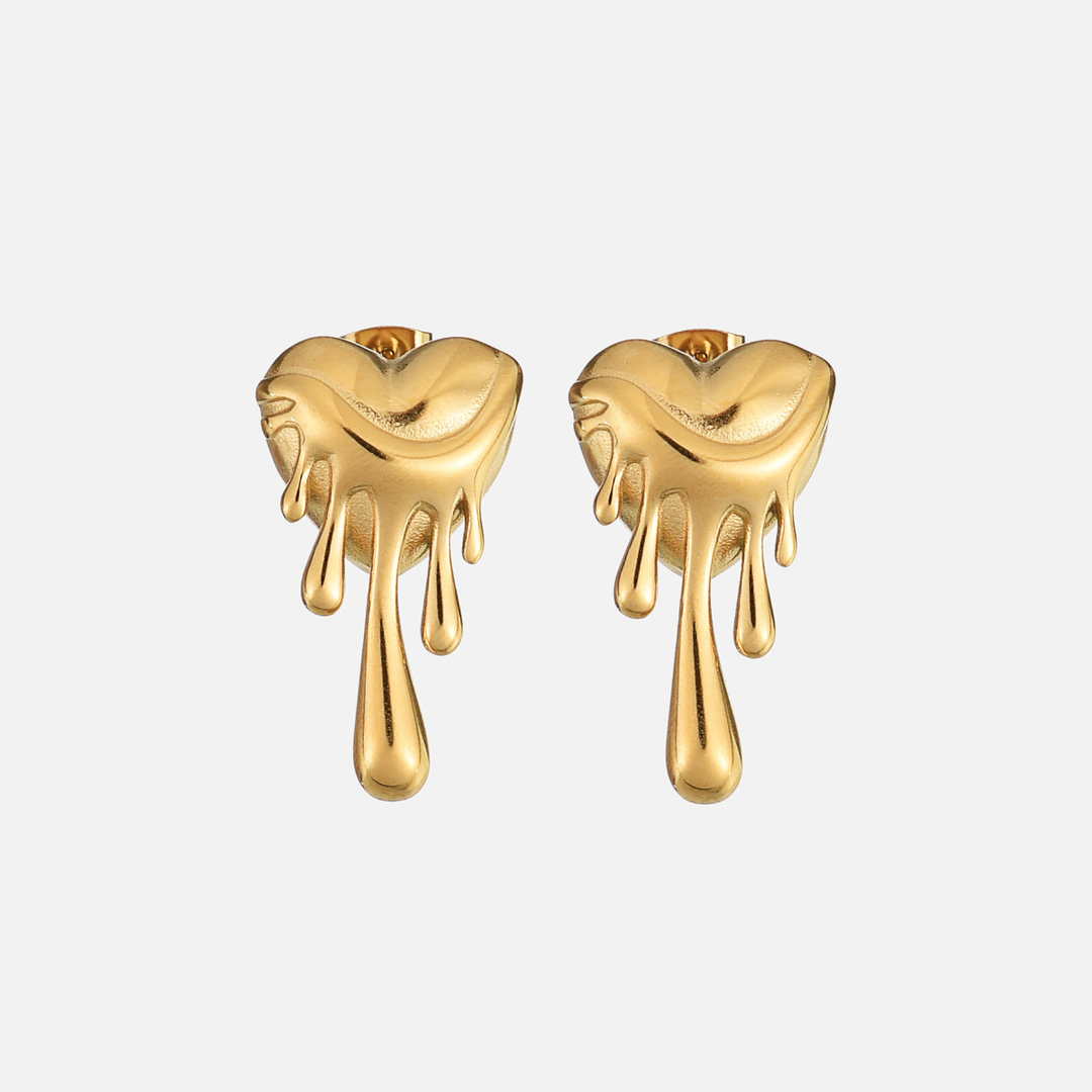 Pair of gold heart-shaped stud earrings with dripping, melted drops, shown from the front on light gray 1