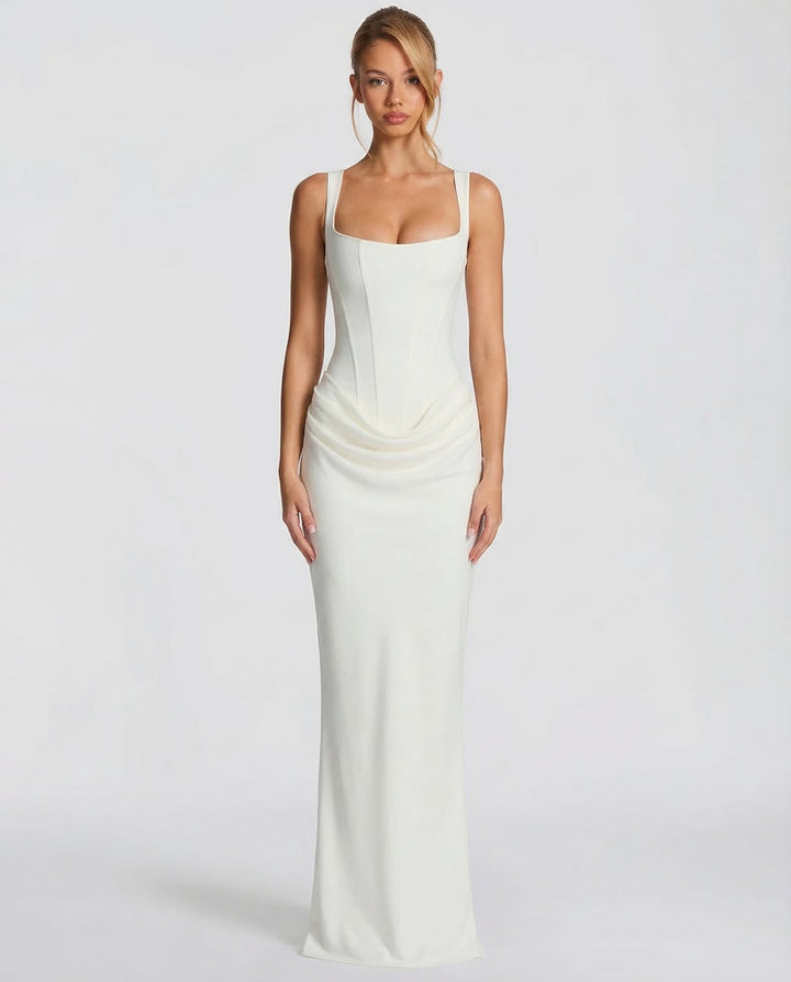 Ivory maxi dress with a square-neck corset bodice and draped hips, front view.