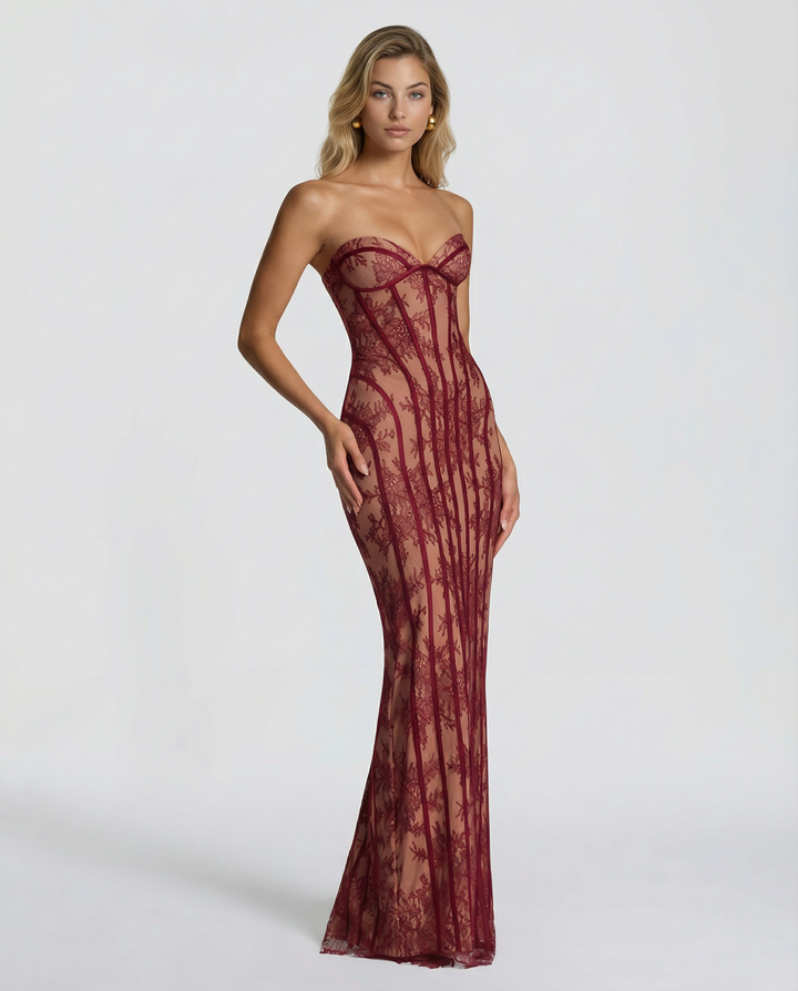 Three-quarter view of the red strapless lace gown, showing the fitted corset bodice and long fitted skirt over a nude lining.