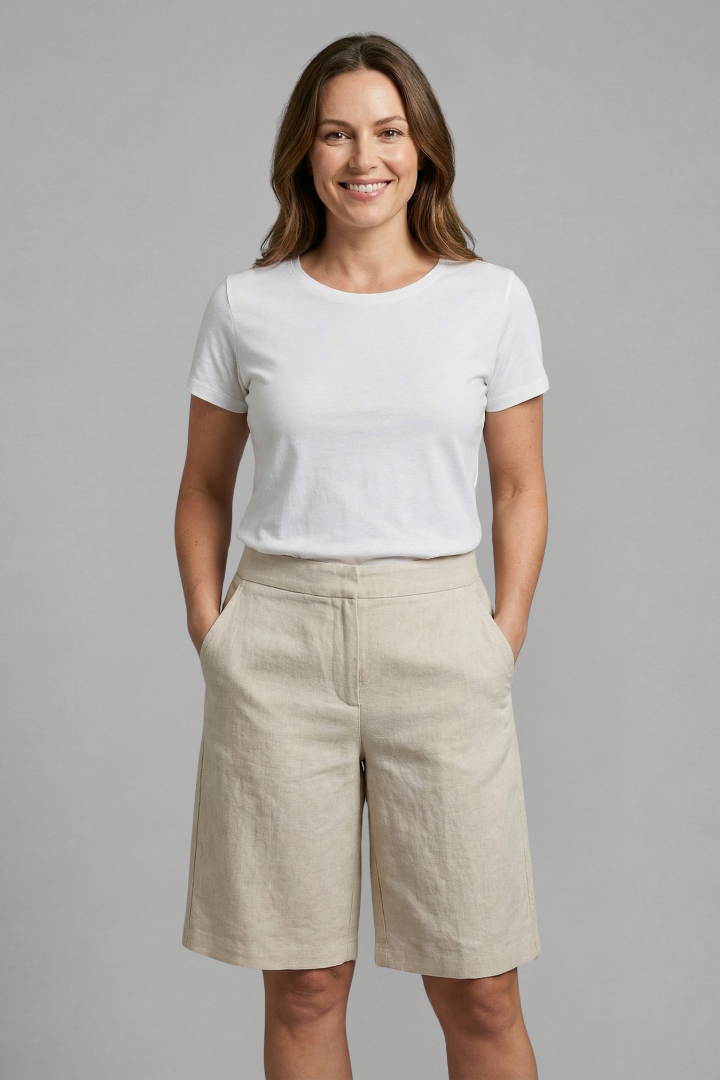 Model wearing beige high-waisted linen shorts, front view.