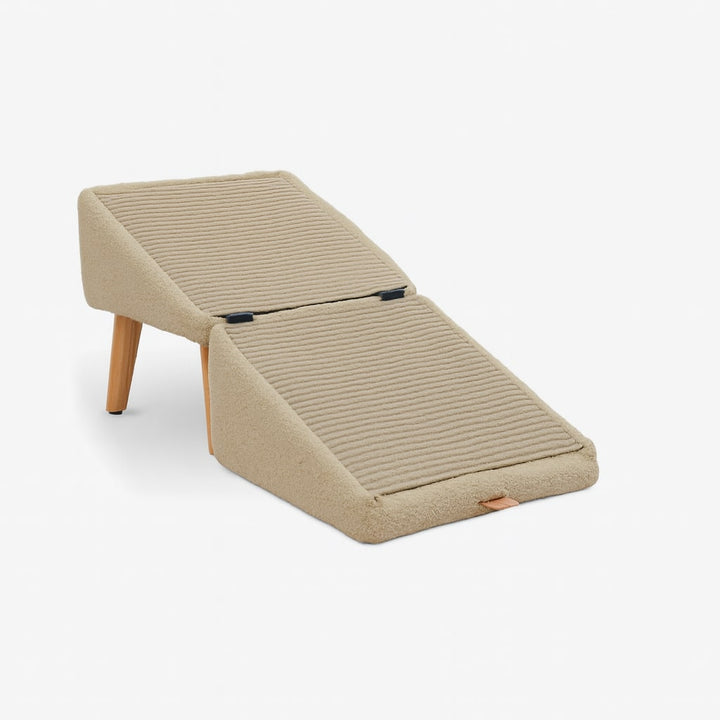Grey pet step unfolded into a gently sloped two-section ramp with a ribbed surface and wooden legs.
