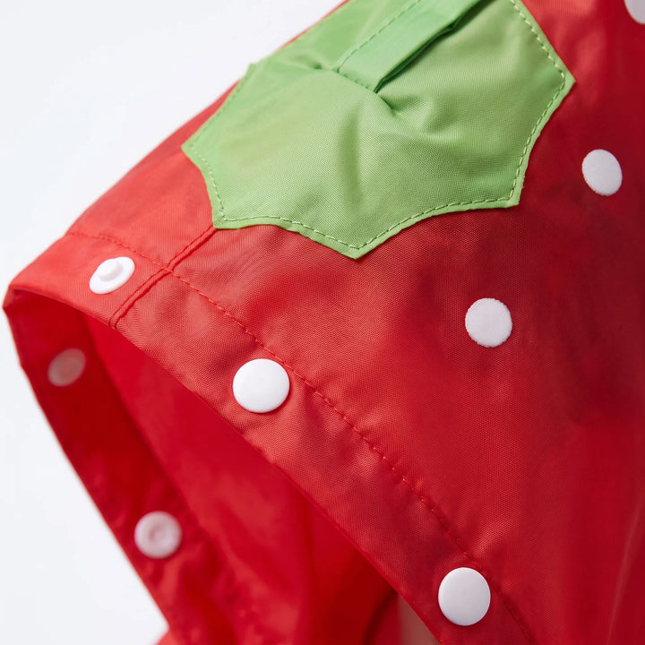 Close-up of the red strawberry-style hood with white dots, green leaf patch, stitching and white snap buttons. 6