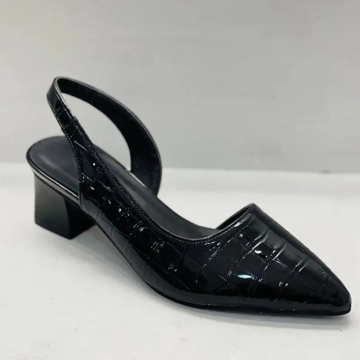 Single black glossy croc-embossed slingback shown from a three-quarter angle on a light surface 3