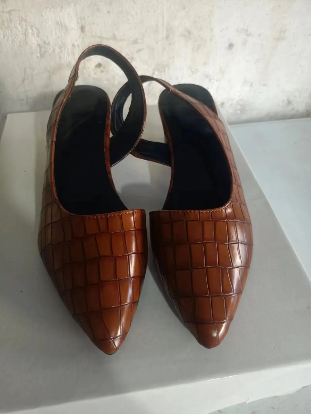 Pair of brown croc-embossed slingbacks seen from above, showing pointed toes and black insoles 7