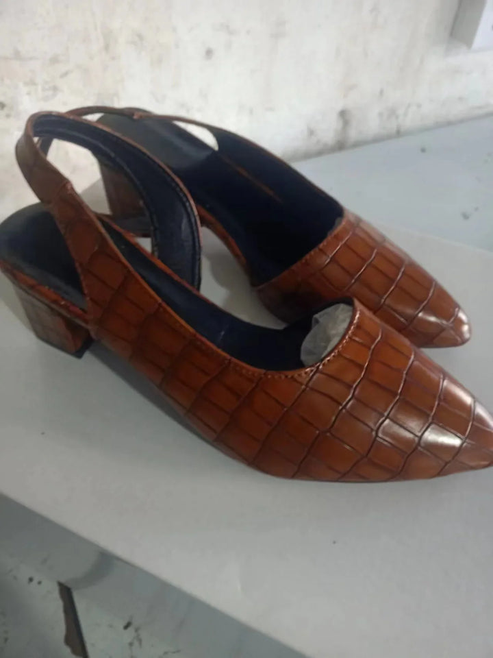 Pair of brown croc-embossed slingbacks angled to show the pointed toe, back strap and block heel 8