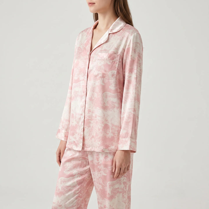 Three-quarter side view of a model in the long-sleeve pink pajama shirt, showing the rounded chest pocket, piped cuffs and satin-like sheen. 4