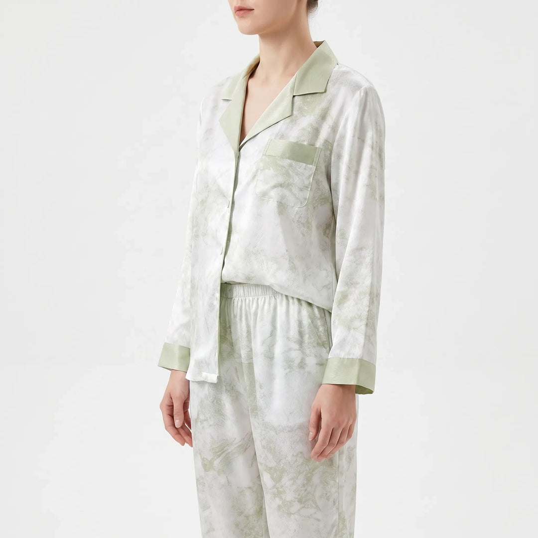Side view of the pajama top with green collar, patch pocket and cuffs, worn with elastic-waist pants. 4