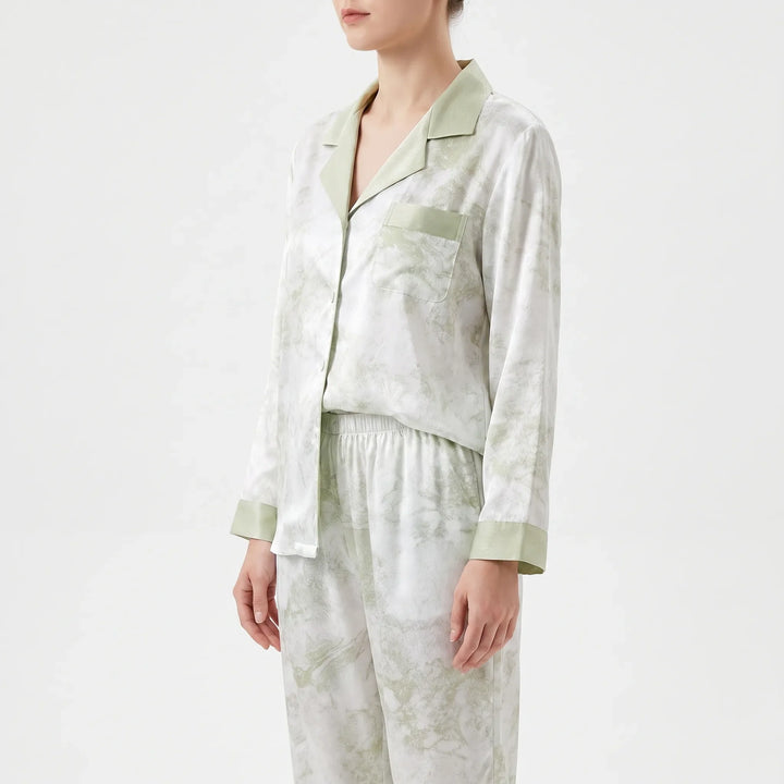 Side view of the pajama top with green collar, patch pocket and cuffs, worn with elastic-waist pants. 4