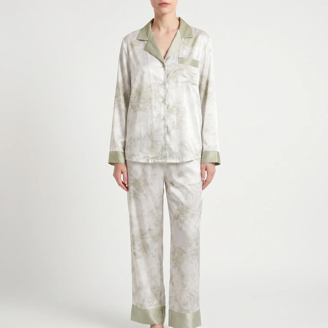 Full-length front view of the white pajama set with green marbled print, green collar, pocket trim and wide green hem cuffs. 7