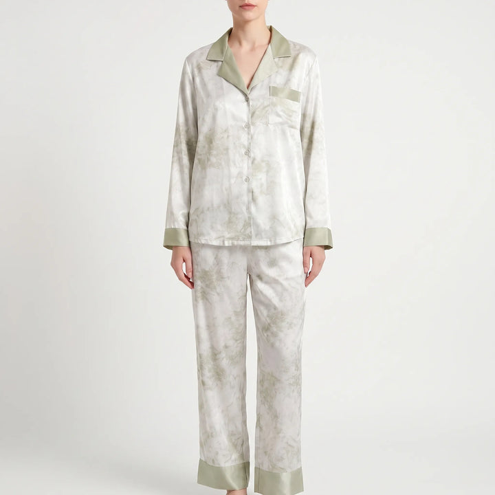Full-length front view of the white pajama set with green marbled print, green collar, pocket trim and wide green hem cuffs. 7