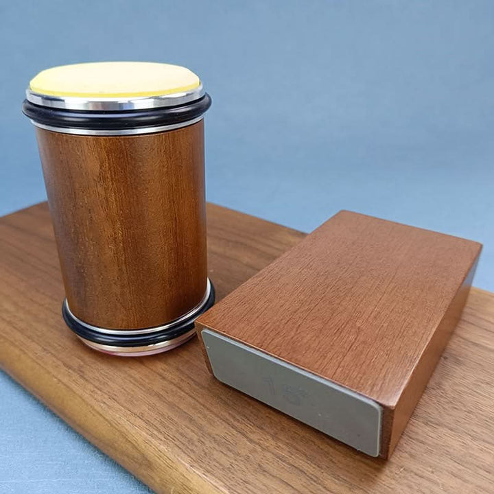 Wooden roller with a yellow-toned end disc standing next to the angle block on a wooden board 5