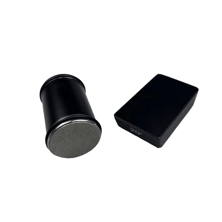 Black matte cylinder showing its gray diamond-coated end disc, beside a black angle block 1