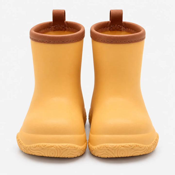 Front view of golden yellow rain boots with brown collars and pull loops, showing the swirl-patterned soles. 11