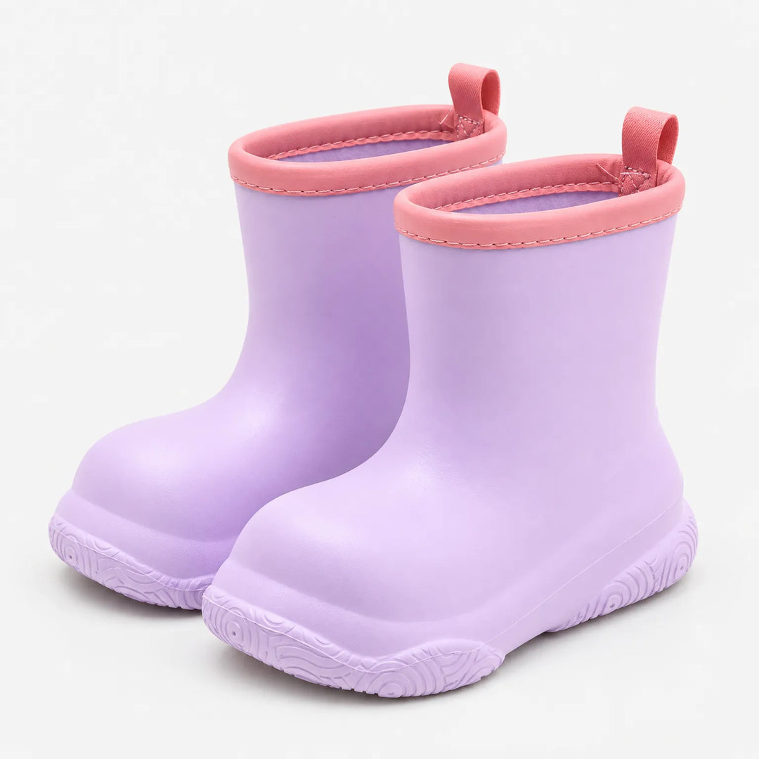 Pair of lilac purple rain boots with pink collars and pull loops, angled view on a white background. 4
