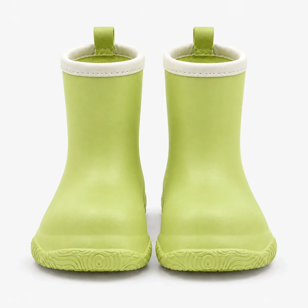 Front view of light green rain boots with cream collars and green pull loops, showing the swirl-patterned soles. 7