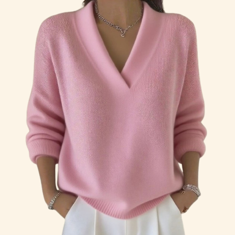 Model wearing the knit V-neck sweater in soft pink with a relaxed fit.