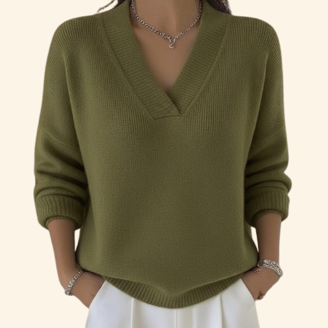Model wearing the knit V-neck sweater in olive green with long sleeves.