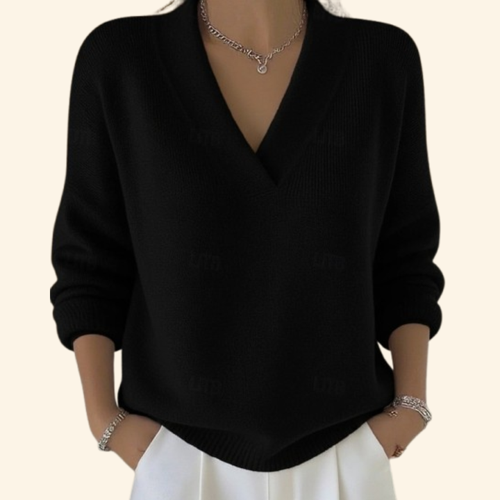 Model wearing the knit V-neck sweater in black with long sleeves.