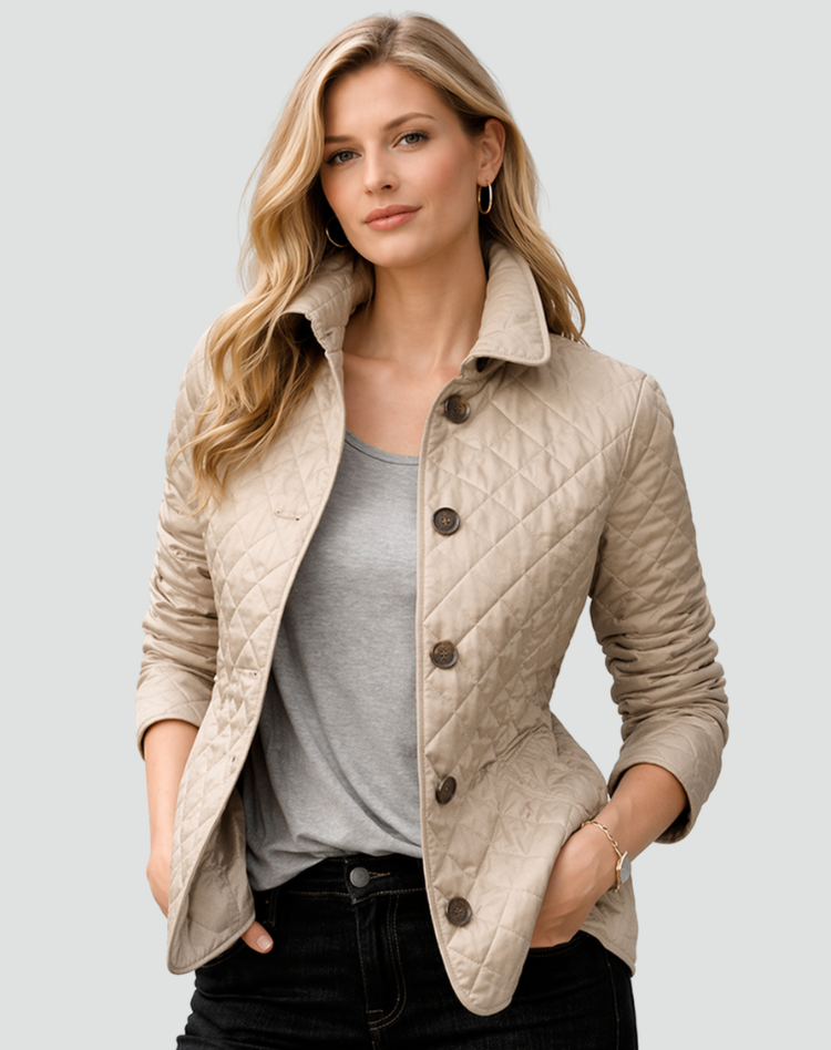 Beige quilted jacket with brown buttons, worn open over a gray tee and black jeans.