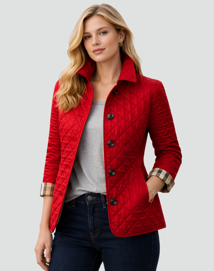 Red quilted jacket with black buttons and checked cuffs, paired with a gray tee and dark jeans.