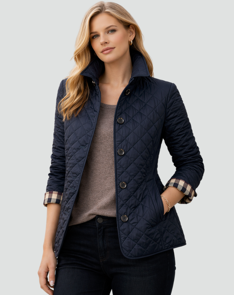 Navy quilted jacket with checked cuff lining, worn over a taupe top and dark jeans.
