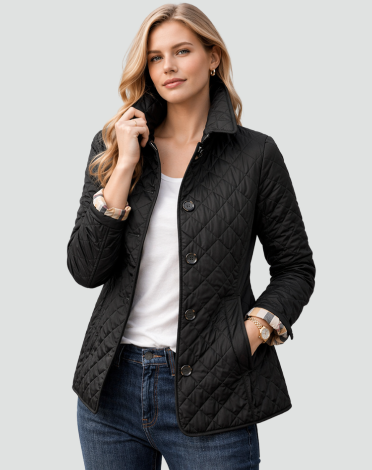 Black diamond-quilted jacket with plaid cuffs turned back, worn over a white tee and jeans.