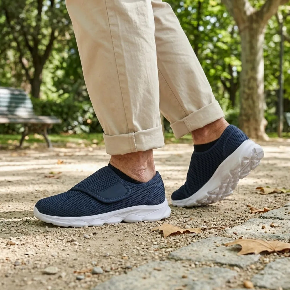 Person walking on a gravel park path in navy mesh strap shoes with white soles and rolled beige pants 2