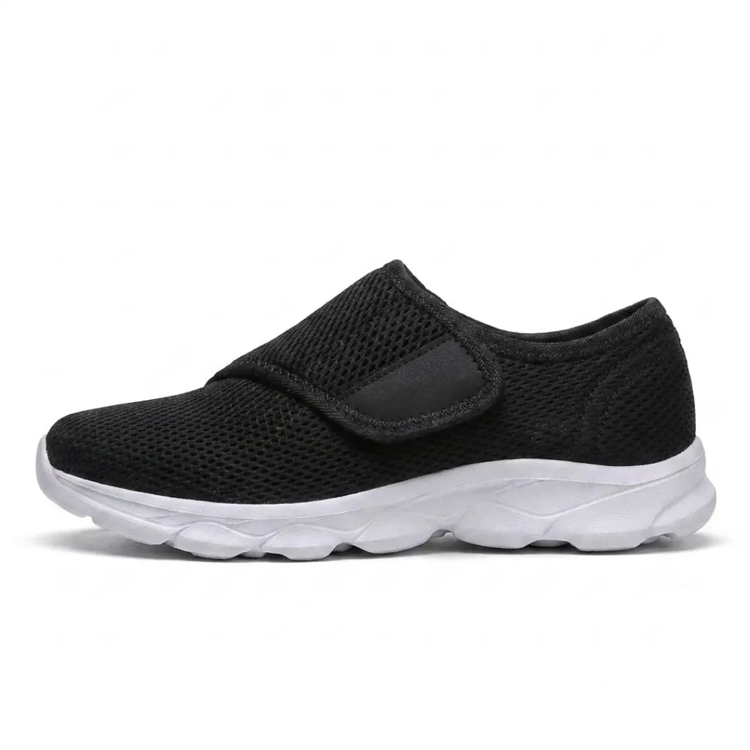Side view of a black mesh shoe with a white sole and a single hook-and-loop strap 19