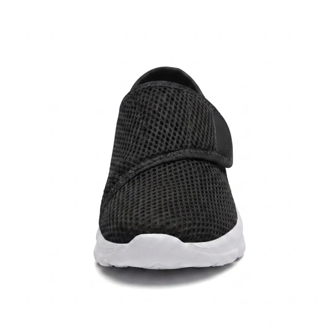 Front view of a black mesh shoe showing the wide rounded toe box and diagonal hook-and-loop strap 26