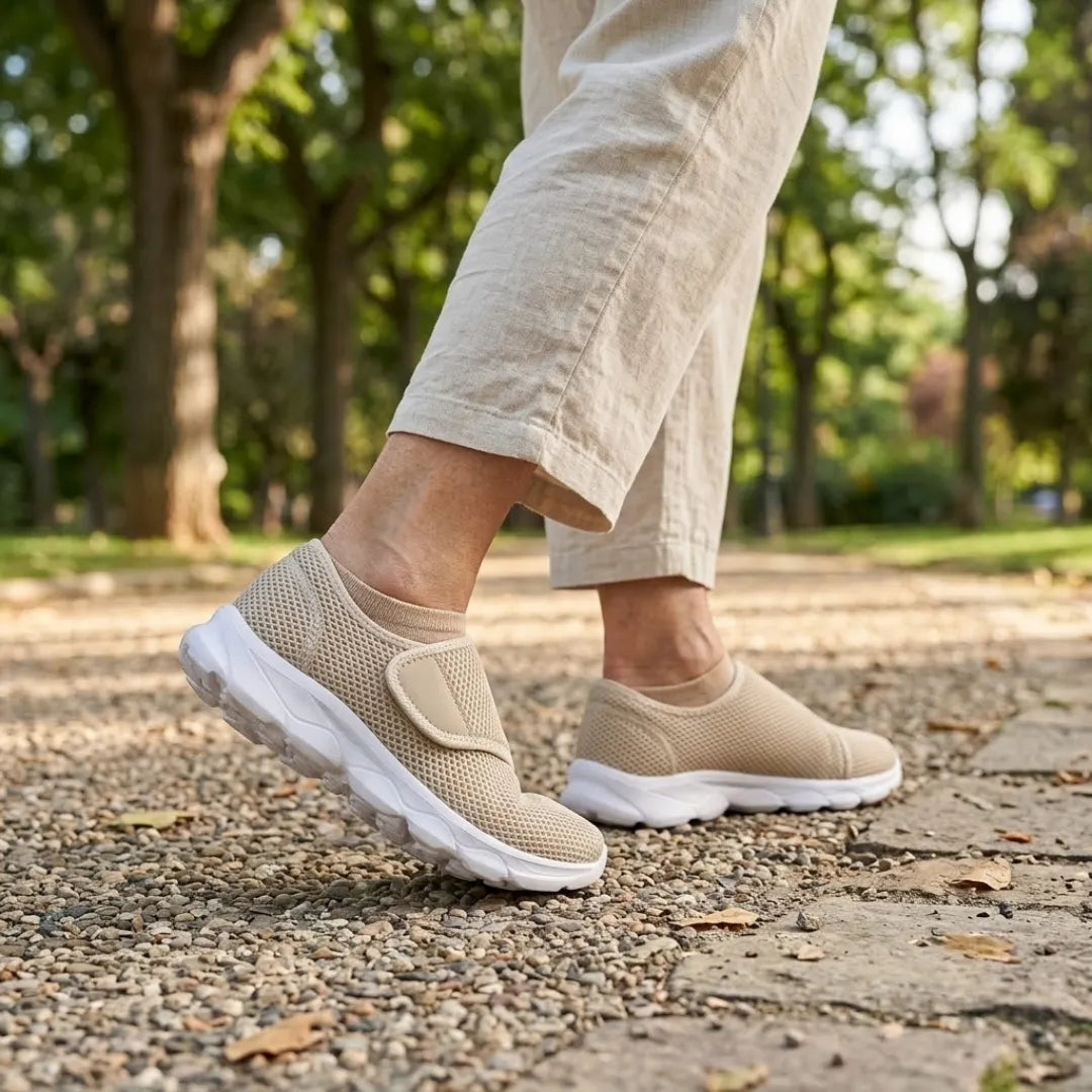 Person walking on a gravel park path in beige mesh strap shoes, beige socks and linen pants 29