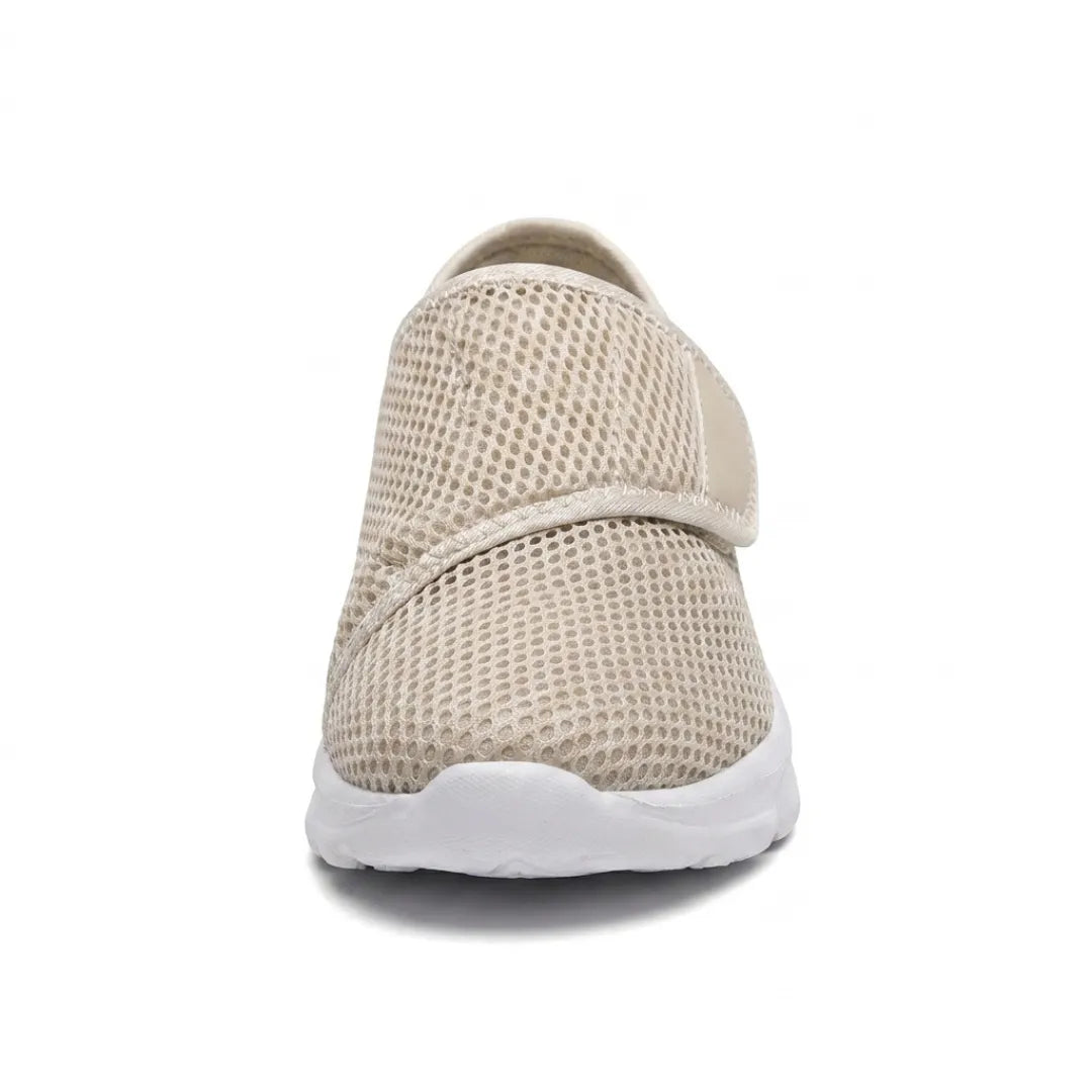 Front view of a beige mesh shoe showing the wide rounded toe box and diagonal hook-and-loop strap 35