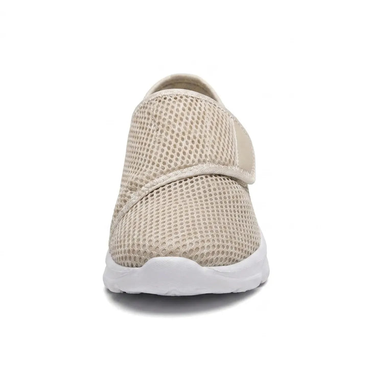 Front view of a beige mesh shoe showing the wide rounded toe box and diagonal hook-and-loop strap 35