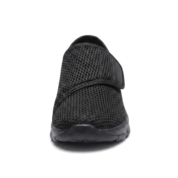 Front view of an all-black mesh shoe showing the rounded toe and the strap across the instep 17