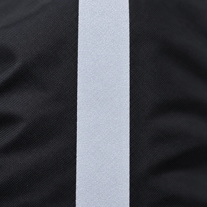 Close-up of the light gray reflective strip running down the woven black fabric of the cover. 5