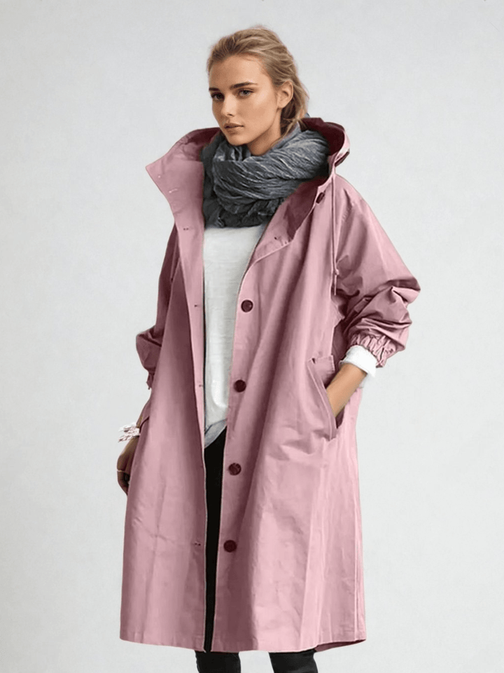 Model in the dusty pink hooded coat, buttoned over a white top, hand in pocket, with a gray scarf 6