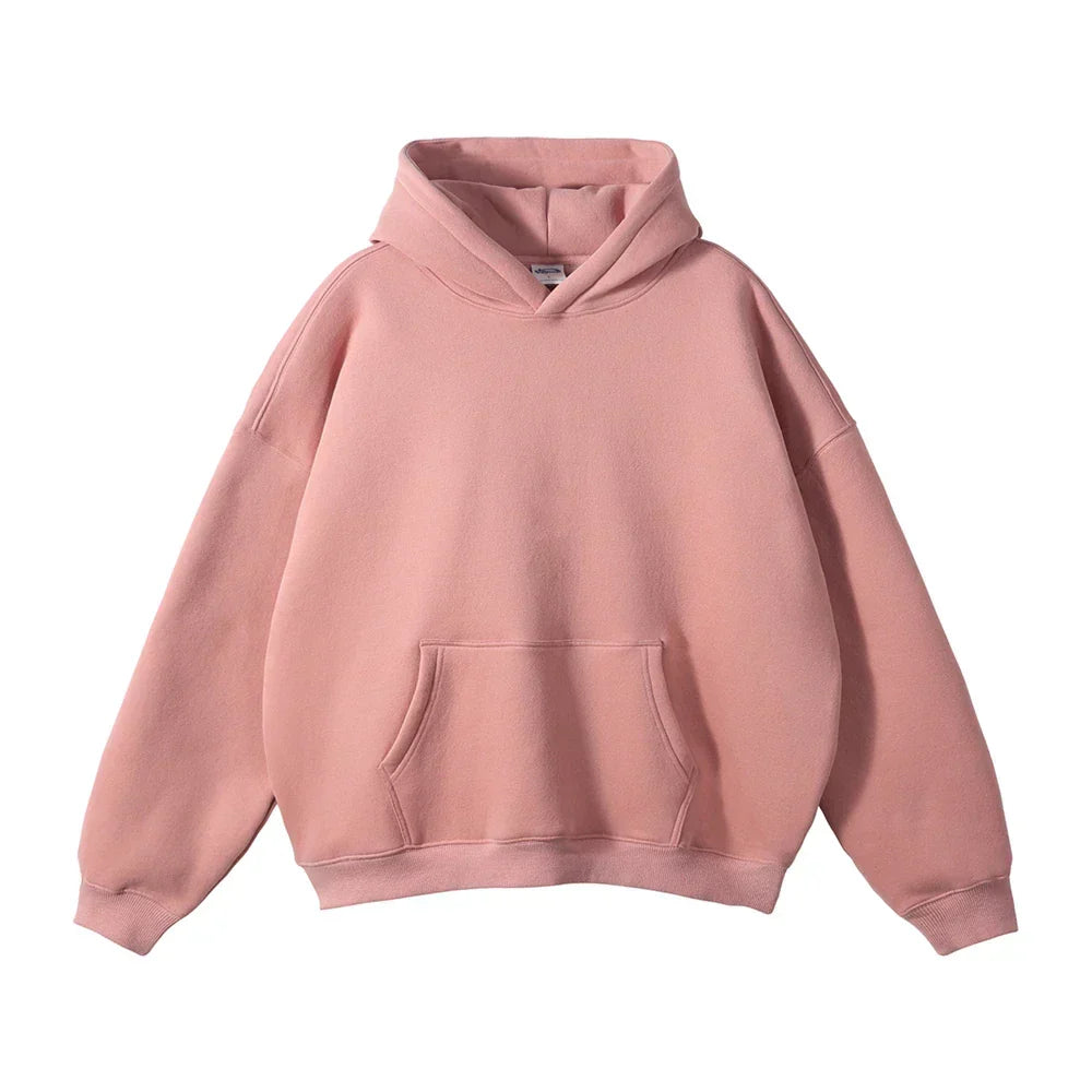 Front view of the hoodie in dusty pink, laid flat, with the kangaroo pocket, drop shoulders and ribbed cuffs.