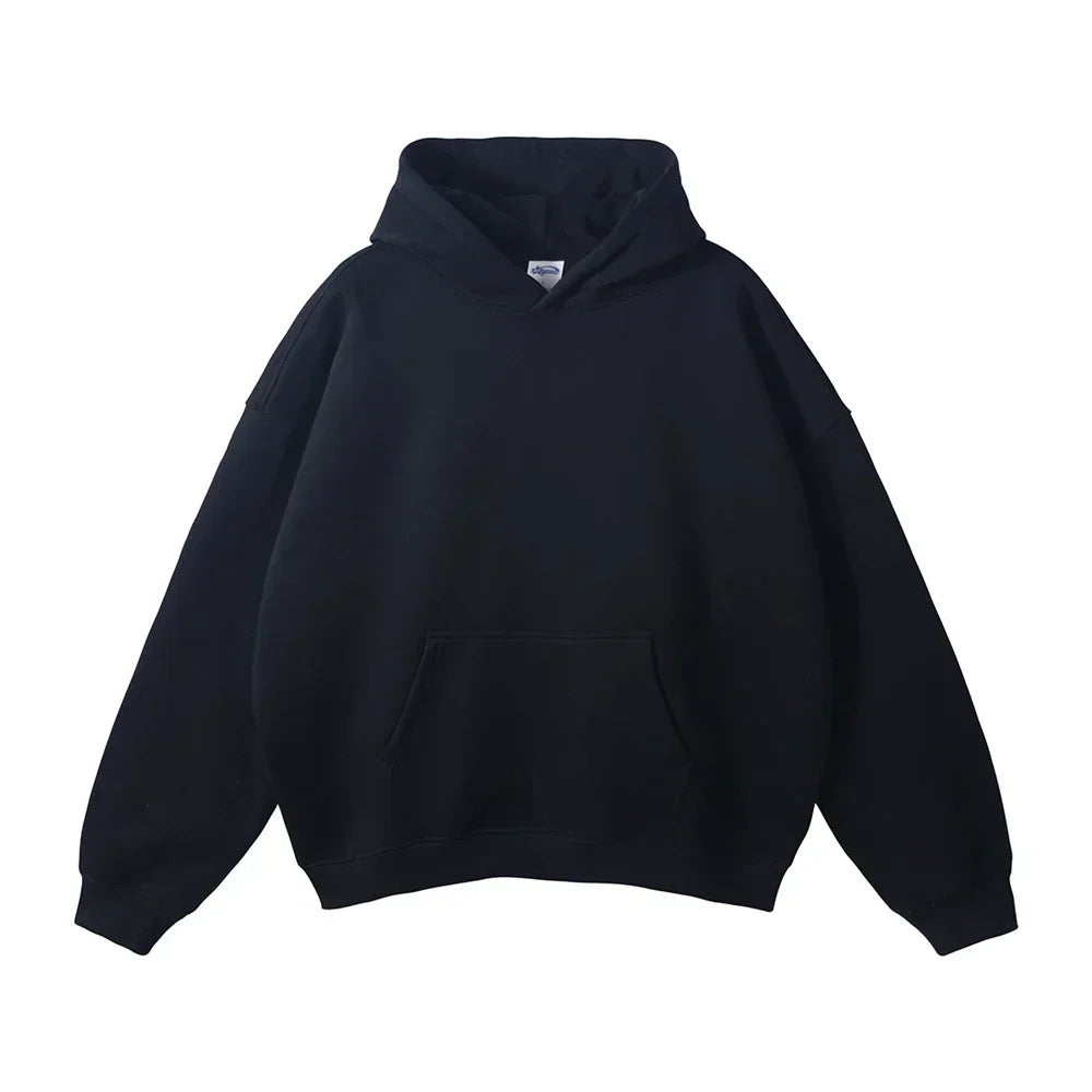 Front view of the hoodie in solid black, laid flat, with the hood, front pocket and ribbed cuffs.