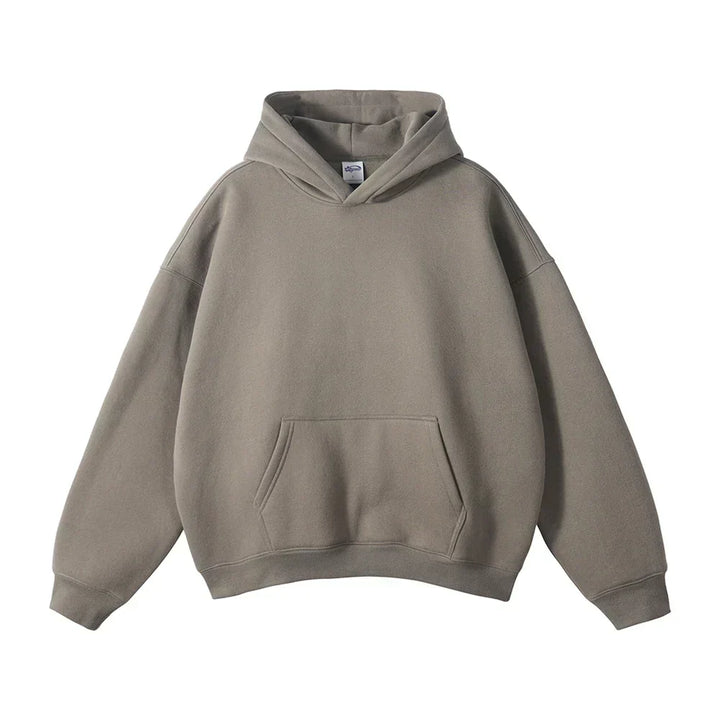 Front view of the hoodie in taupe gray, laid flat, with drop shoulders and a large front pocket.