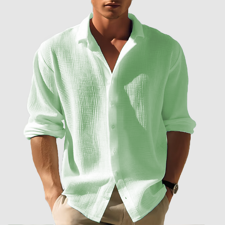 Man wearing the textured shirt in pale mint green, sleeves rolled, hands in khaki pants pockets 3