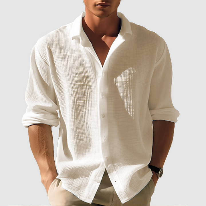 Man wearing the textured shirt in warm cream, sleeves rolled, hands in khaki pants pockets 5