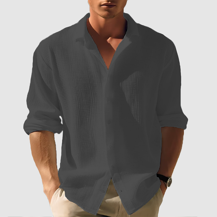 Man wearing the textured shirt in dark charcoal gray, sleeves rolled, hands in khaki pants pockets 7