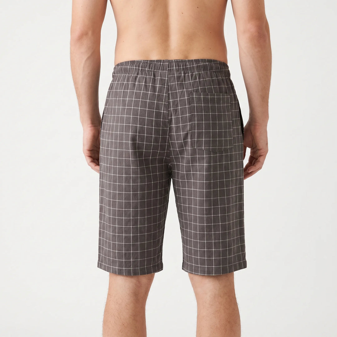 Back view of the gray check shorts on a shirtless model, showing the elastic waistband and a single patch pocket. 3