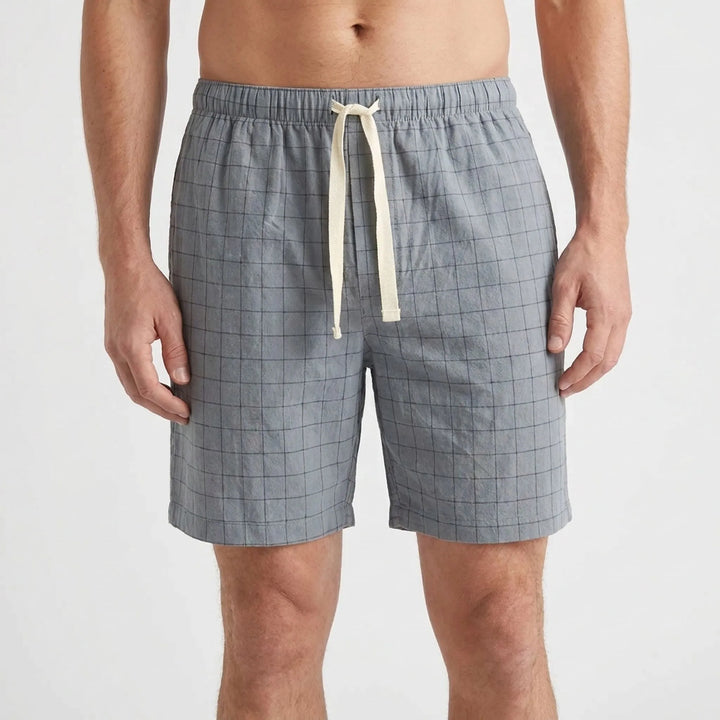 Front view of a lighter blue-gray version with dark grid check, cream drawstring and a slightly shorter length. 7