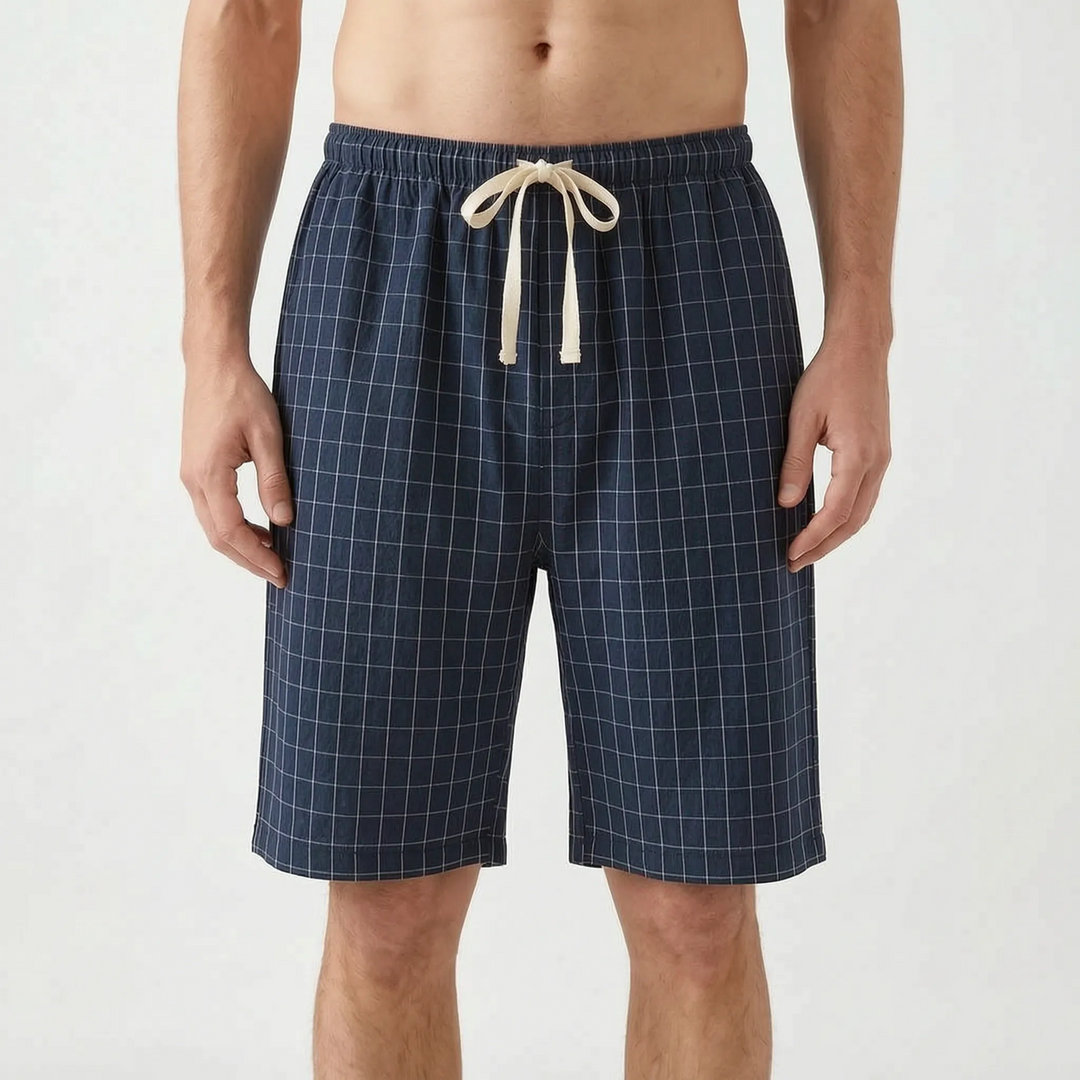 Front view of the navy blue colorway with a fine white grid check and cream drawstring tied in a bow. 8