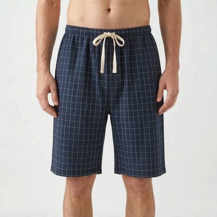 Front view of the navy blue colorway with a fine white grid check and cream drawstring tied in a bow. 8