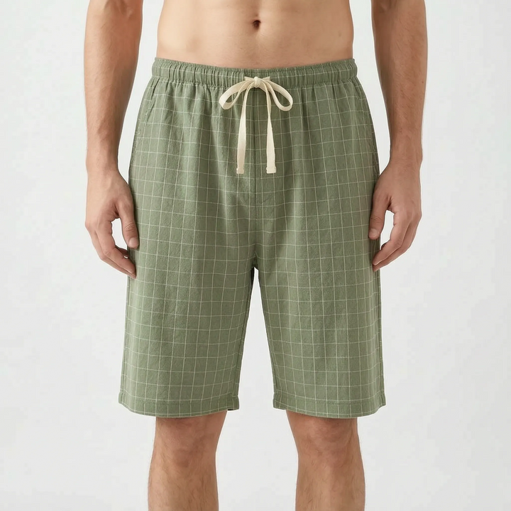 Front view of the sage green colorway with a light grid check and cream drawstring tied in a bow. 9