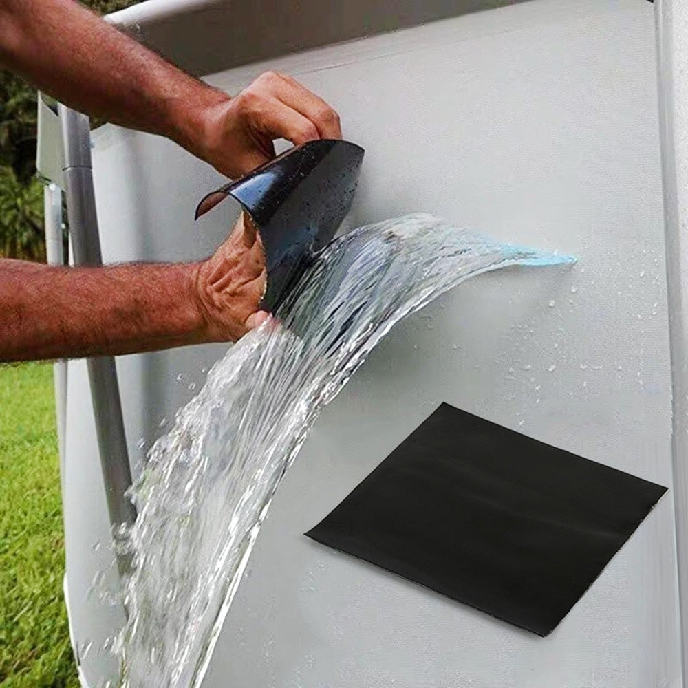 Man peels a black patch off a white pool wall as water streams over it.