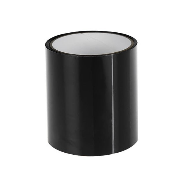 Black roll of repair tape standing upright on a white background with its white inner core visible.
