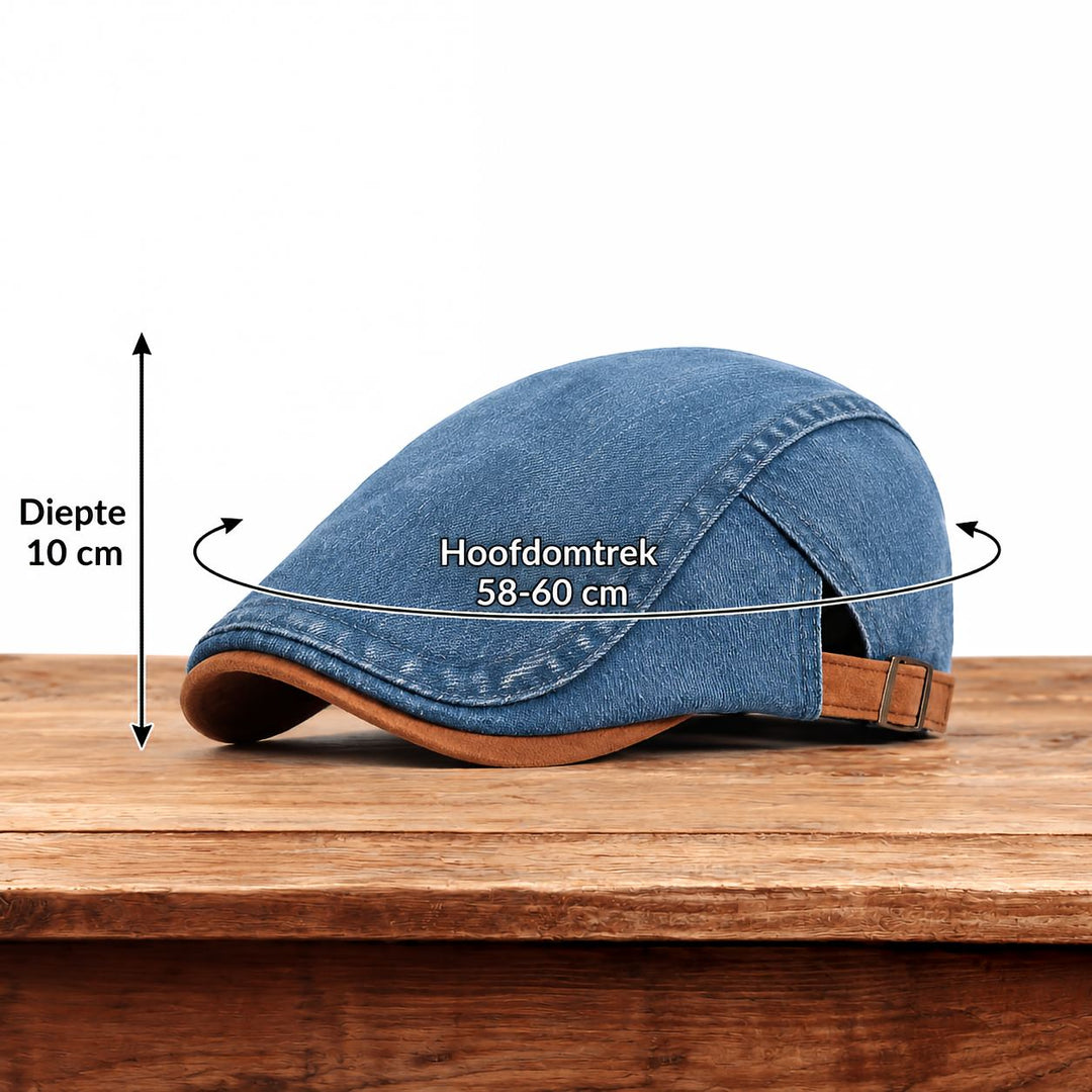 Men's blue denim flat cap on a wooden table with depth and head circumference measurements.
